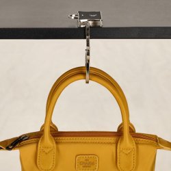 Charm London taskeholder i brug p bordkant med taske